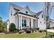 Side view of a charming white two-story home with a manicured lawn at 208 Idylwilde Way, Canton, GA 30115