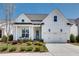 Charming white two-story home with a well-manicured lawn and inviting front porch at 208 Idylwilde Way, Canton, GA 30115