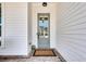 Inviting entrance with a stylish front door, brick walkway, and modern exterior lighting at 208 Idylwilde Way, Canton, GA 30115