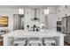 Bright kitchen featuring a spacious island with quartz countertops, seating, and stainless steel appliances at 208 Idylwilde Way, Canton, GA 30115