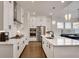 Modern white kitchen with stainless steel appliances and marble countertops at 208 Idylwilde Way, Canton, GA 30115