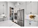 Modern kitchen with stainless steel appliances, a pantry, and ample white cabinetry for plenty of storage at 208 Idylwilde Way, Canton, GA 30115