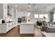 Well-lit kitchen featuring white cabinets, stainless steel appliances, a center island, and hardwood floors at 208 Idylwilde Way, Canton, GA 30115