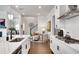 Open kitchen with hardwood floors, quartz countertops, an island, and a view of the living area at 208 Idylwilde Way, Canton, GA 30115