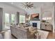 Cozy living room with comfortable seating, fireplace, brick accents, and abundant natural light at 208 Idylwilde Way, Canton, GA 30115