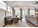 Bright dining area featuring a modern chandelier, and an open layout to the adjacent living room at 208 Idylwilde Way, Canton, GA 30115