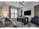 Comfortable office with a couch, ceiling fan, and TV at 208 Idylwilde Way, Canton, GA 30115