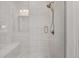 Modern bathroom featuring a frameless glass shower door, tile surround and a built-in seat at 208 Idylwilde Way, Canton, GA 30115