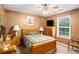 A comfy bedroom with a ceiling fan, window and dresser at 25 Skylar Dr, Covington, GA 30016