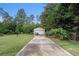 Long driveway leads to a detached garage amidst lush landscaping at 25 Skylar Dr, Covington, GA 30016