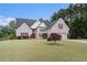 Charming brick home featuring a well-manicured lawn and attached two car garage at 25 Skylar Dr, Covington, GA 30016