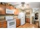 Cozy kitchen with wood cabinets, modern appliances, and hardwood floors at 25 Skylar Dr, Covington, GA 30016