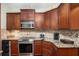Well-equipped kitchen with stainless steel appliances and granite countertops at 25 Skylar Dr, Covington, GA 30016