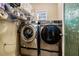 Laundry room featuring front load washer and dryer set with storage at 25 Skylar Dr, Covington, GA 30016