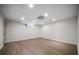 Bright basement featuring modern gray wood-look flooring, neutral walls, recessed lighting and an egress window at 2701 Gentry Dr, Douglasville, GA 30135