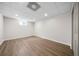 Bright basement featuring modern gray wood-look flooring, neutral walls, recessed lighting and an egress window at 2701 Gentry Dr, Douglasville, GA 30135
