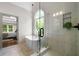 Bright bathroom featuring glass shower, tub, and large window with a garden view at 2701 Gentry Dr, Douglasville, GA 30135