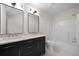 Bathroom featuring black cabinets, marble countertop and double vanity at 2701 Gentry Dr, Douglasville, GA 30135
