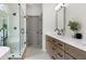 Bathroom featuring separate tub, glass shower, double sinks, stone counters, and wood cabinets at 2701 Gentry Dr, Douglasville, GA 30135