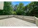 Spacious outdoor deck with built-in benches and lush trees provides a peaceful setting at 2701 Gentry Dr, Douglasville, GA 30135
