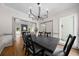 Elegant dining room featuring a stylish chandelier, modern decor, and views into the living space at 2701 Gentry Dr, Douglasville, GA 30135