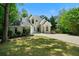 Charming two-story home with landscaped yard, a well-manicured lawn, and an extensive driveway at 2701 Gentry Dr, Douglasville, GA 30135