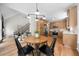 Bright kitchen and dining area with wood floors, stainless appliances, and a staircase nearby at 2701 Gentry Dr, Douglasville, GA 30135
