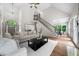Expansive living area with vaulted ceilings, large windows, and a view into the dining room at 2701 Gentry Dr, Douglasville, GA 30135