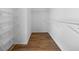 Spacious walk-in closet with hardwood floors and wire shelving for optimal storage solutions at 2701 Gentry Dr, Douglasville, GA 30135