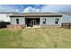 Spacious backyard with lawn, covered patio, and partial fencing for pets at 3785 Newbury Place Dr, Loganville, GA 30052