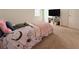 Comfortable bedroom featuring plush carpeting and bright natural light from a window at 3785 Newbury Place Dr, Loganville, GA 30052