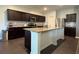 Contemporary kitchen with dark cabinets, stainless steel appliances, and granite countertops at 3785 Newbury Place Dr, Loganville, GA 30052