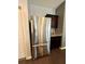 Stainless steel refrigerator stands next to dark cabinets and granite countertop in kitchen at 3785 Newbury Place Dr, Loganville, GA 30052