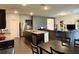 Open concept living room with center island in kitchen and hardwood floors throughout at 3785 Newbury Place Dr, Loganville, GA 30052