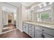 Primary bathroom featuring dual sinks, granite countertops, and a large walk-in shower at 405 Maple Rdg, White, GA 30184