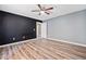 Bedroom with wood floors, ceiling fan, and view to entry hallway at 405 Maple Rdg, White, GA 30184