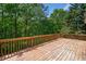 View from a wood deck overlooking a densely wooded backyard with mature green trees at 405 Maple Rdg, White, GA 30184