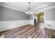 Formal dining room with decorative trim and views of the living room at 405 Maple Rdg, White, GA 30184