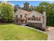 Beautiful home with an attached garage, well-maintained lawn, and wooded surroundings at 405 Maple Rdg, White, GA 30184