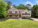 Charming two-story home with a welcoming front porch and lush green lawn at 405 Maple Rdg, White, GA 30184