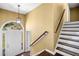 Bright foyer with hardwood floors, staircase, and elegant light fixture at 405 Maple Rdg, White, GA 30184