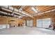 Spacious garage featuring multiple doors, ample storage, and workshop area at 405 Maple Rdg, White, GA 30184
