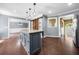 Open floor plan boasts kitchen with island, adjacent dining, and a view to the entry at 405 Maple Rdg, White, GA 30184