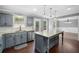Spacious kitchen with a large island, granite countertops, stainless steel appliances and hardwood floors at 405 Maple Rdg, White, GA 30184