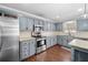 Well-lit kitchen features stainless steel appliances, ample storage, and updated countertops at 405 Maple Rdg, White, GA 30184