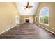 Open living room featuring vaulted ceiling, fireplace, and hardwood floors at 405 Maple Rdg, White, GA 30184
