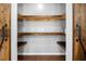 Walk-in pantry with custom wood shelves and barn doors at 405 Maple Rdg, White, GA 30184