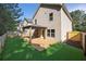 Spacious backyard featuring well-manicured grass, a wood fence, and a covered patio area at 506 Tallapoosa Trl, Woodstock, GA 30188