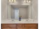 Bathroom featuring a double vanity with a large mirror and decorative flower arrangement at 506 Tallapoosa Trl, Woodstock, GA 30188