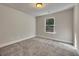 Cozy bedroom with carpet floors, a window, and neutral paint, perfect for relaxation at 506 Tallapoosa Trl, Woodstock, GA 30188